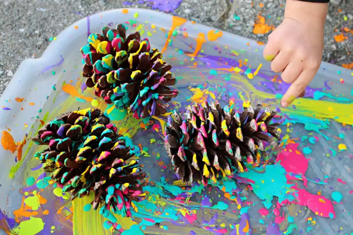 A child pointed to 3 examples of splatter painted pine cone art.